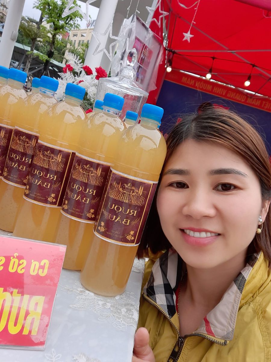 Chị Nguyễn Thị Huyền Trang bên sản phẩm rượu Bâu Bằng Cả
